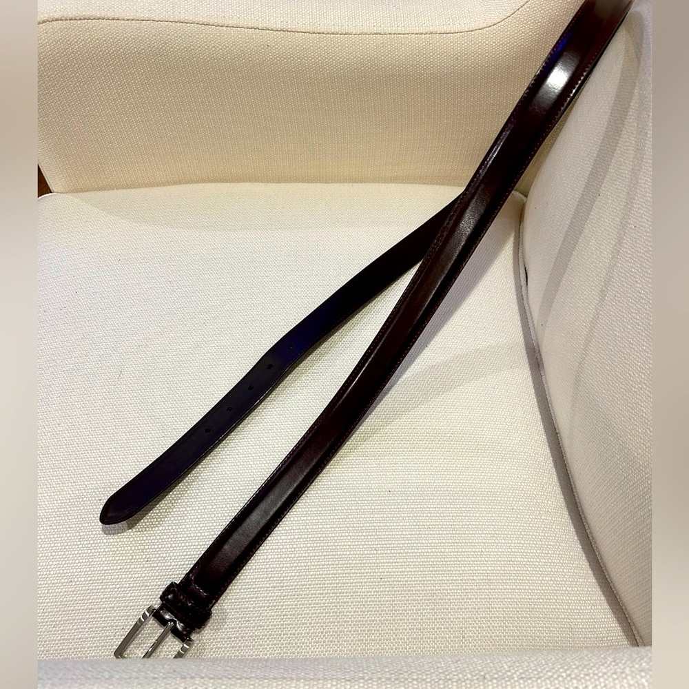 Brown leather belt with silver buckle.